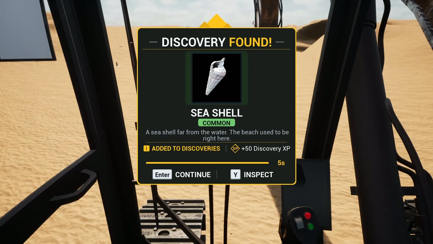 The Discovery Found card for a sea shell, seen from the excavator cab